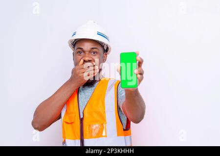Architects holding a smartphone with isolated blank screen. Stock Photo