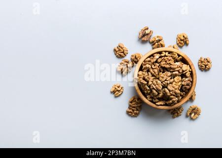 Fresh healthy walnuts in bowl on colored table background. Top view Healthy eating bertholletia concept. Super foods. Stock Photo