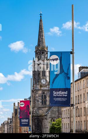 Fringe festival banners on Royal Mile with Tron Kirk church spire, Edinburgh, Scotland, UK Stock Photo