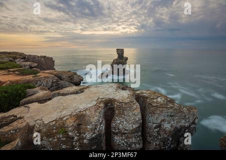 Sunset behind the rock stack at Cabo Carvoeiro with stormy sea, Peniche, Central Region, Portugal, Europe Stock Photo