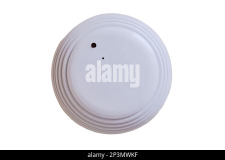 Smoke detector of fire alarm, the white background of the wall, isolated on a white background. Sensor on beige ceiling, isolated on a white backgroun Stock Photo