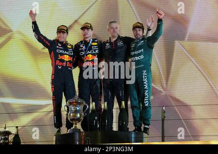 Sakhir, Bahrain. 05th Mar, 2023. Motorsport: Formula 1 World Championship, Bahrain Grand Prix, race. Winner Max Verstappen (2nd from left) from the Netherlands of Team Oracle Red Bull stands on the podium alongside second-placed Sergio Perez (l) from Mexico of Team Oracle Red Bull and third-placed Fernando Alonso (r) from Spain of Team Aston Martin. Credit: Hasan Bratic/dpa/Alamy Live News Stock Photo