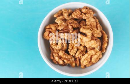 Organic walnuts in a bowl, selective focus. Stock Photo