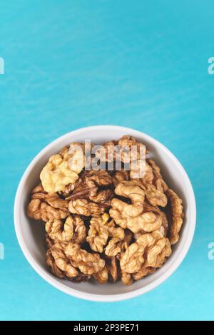 Organic walnuts in a bowl, selective focus. Stock Photo