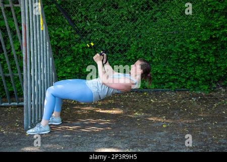 View of European women during a sport training outdoors on a public area in the summer Stock Photo