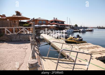 Nessebar, Bulgaria - July 21, 2014: Floating piers with moored pleasure boats in old Nesebar, ordinary people are on the street Stock Photo