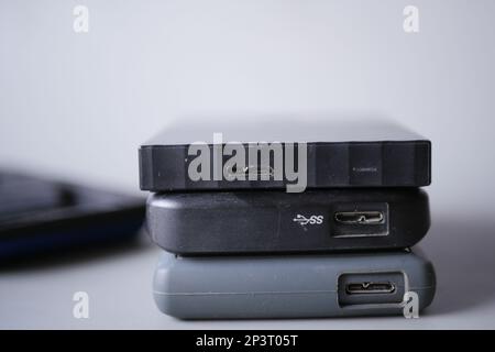 stack of external hard drives on table  Stock Photo