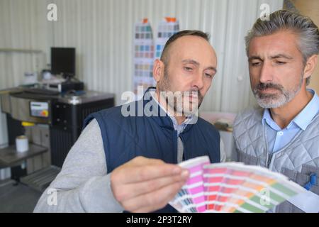 interior designer showing colour wheel to customer Stock Photo