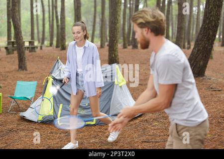 couple on camping trip playing badminton Stock Photo
