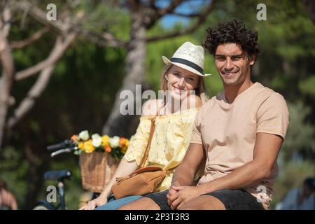 beautiful happy couple siting in the park enjoying the day Stock Photo
