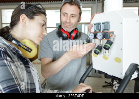 man and woman with machine cnc Stock Photo