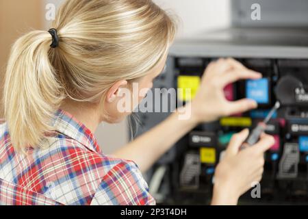 female technician fixing a printer Stock Photo