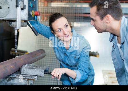 engineer training apprentices on cnc machine Stock Photo