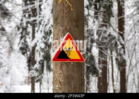 Steep slope warning sign for cyclists in Ruskeasuo, Helsinki, Finland Stock Photo