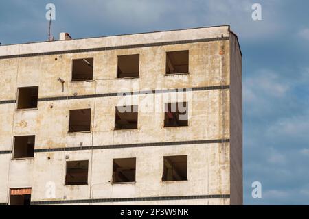 A ruined house with broken collapsed empty windows Stock Photo