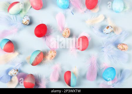 Painted Easter eggs in crimson and blue on a blue background with a place for text. Happy Easter concept. Greeting card, copy space Stock Photo