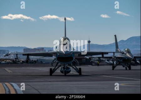 A pair of F-16 Fighting Falcon fighter jets taxi prior to taking-off for a Red Flag 23-1 training mission at Nellis Air Force Base, Nevada, Feb. 6, 2023. Red Flag takes place over the Nevada Test and Training Range and provides the warfighter a flexible, realistic and multi-dimensional battle space to conduct advanced training of U.S. military services and coalition forces. Stock Photo