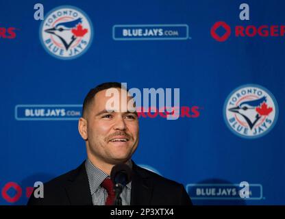 Toronto Blues Jays newly-signed catcher Russell Martin adjusts his jersey  after putting it on during a baseball press conference in Toronto,  Thursday, Nov. 20, 2014. (AP Photo/The Canadian Press, Nathan Denette Stock