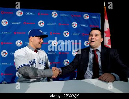 Toronto Blues Jays newly-signed catcher Russell Martin adjusts his jersey  after putting it on during a baseball press conference in Toronto,  Thursday, Nov. 20, 2014. (AP Photo/The Canadian Press, Nathan Denette Stock