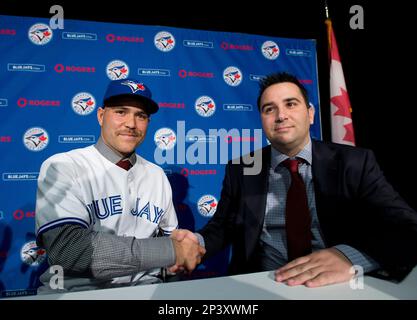 Toronto Blues Jays newly-signed catcher Russell Martin adjusts his jersey  after putting it on during a baseball press conference in Toronto,  Thursday, Nov. 20, 2014. (AP Photo/The Canadian Press, Nathan Denette Stock