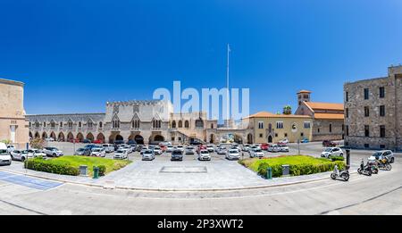 Rhodes, Greece - July 04, 2021: The former Governor's Palace, now used as the the Building of the Prefecture. A panoramic view of the square in front Stock Photo