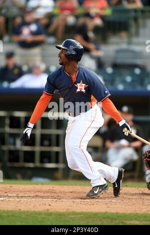 Houston Astros' L.J. Hoes (28) is congratulated by teammate Jose Altuve  (27) after scoring on a single by Brandon Barnes against the Oakland  Athletics during the seventh inning of a baseball game