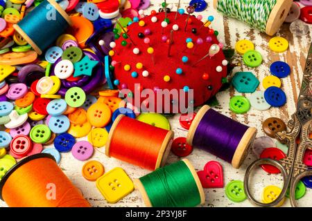 Red Pincushin And Thread With Buttons And Scissors Still life Stock Photo