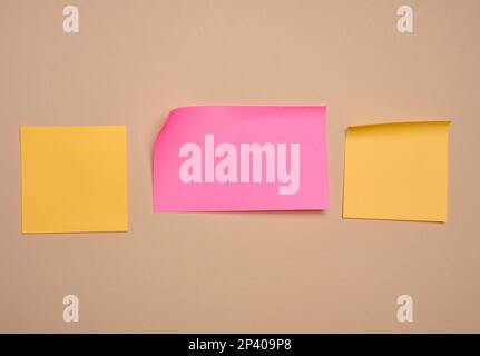 Multi-colored paper stickers for notes on a beige background, a place for writing data, notes Stock Photo