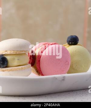Baked macarons with different flavors on the table, dessert Stock Photo