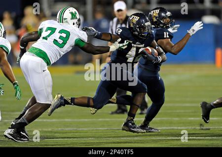 18 October 2014: FIU running back Alex Gardner (1) evades Marshall ...