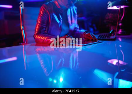 Neon metaverse futuristic concept. Closeup on female with tablet PC exploring graphs in office. Stock Photo