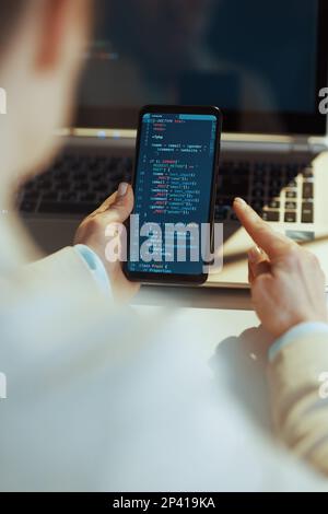 Closeup on modern woman with smartphone developing video game in modern office. Stock Photo