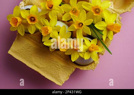 Happy Easter holiday background concept. Easter decoration with flowers in egg shells. Creative easter layout made of daffodils with egg shells Stock Photo