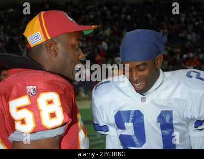 23 NOV 1995: Derrick Thomas (58) of the Kansas City Chiefs and Deion  Sanders (21) of