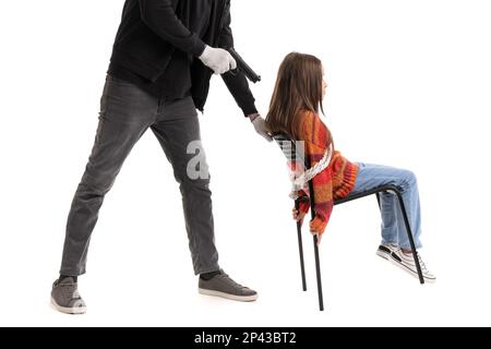 Terrorist with gun and scared little hostage on white background Stock ...