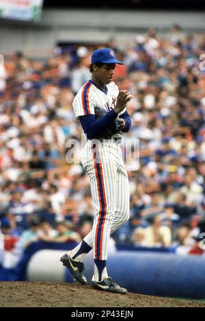 New York Mets starter Dwight “Doc” Gooden wears a jersey with the number  “00” while holding another with his current number “16” in the Mets  clubhouse in Port St. Lucie, Saturday, Feb.