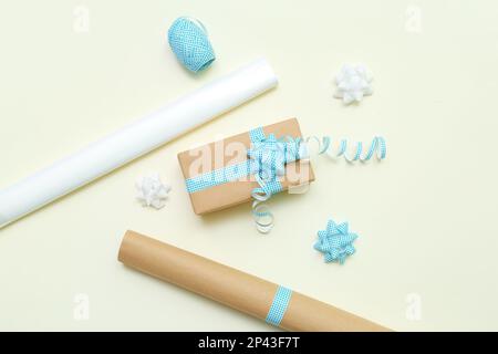 Gift box with bows and wrapping paper on light background Stock Photo