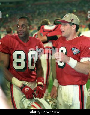 NFL FILE: Jerry Rice (80) and Steve Young (8) of the San Francisco 49ers  during Super Bowl XXIX at Joe Robbie Stadium in Miami, Florida. Young threw  a record 6 touchdowns and