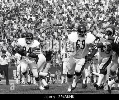 Chicago Bears' Walter Payton (34) comes in for a landing on top of