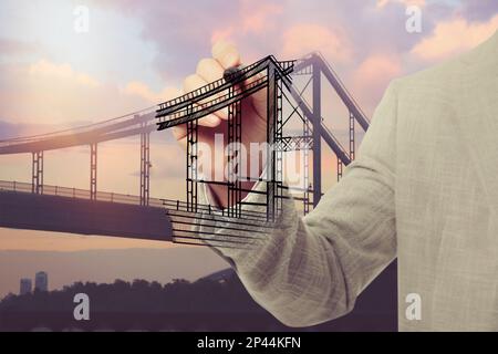 Man drawing picture of bridge, closeup. Business cooperation concept Stock Photo