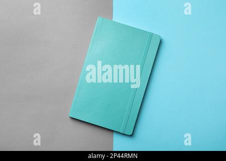 New stylish planner with hard cover on color background, top view Stock Photo