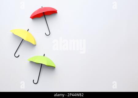 Different umbrellas on white background, top view. Space for text Stock Photo