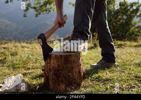 The Lumberjack Is Cutting Wood Or Firewood With Axe Outdoors. Stock Photo,  Picture and Royalty Free Image. Image 97231743.