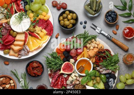 Set of different delicious appetizers served on light grey table, flat lay Stock Photo