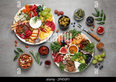 Set of different delicious appetizers served on light grey table, flat lay Stock Photo