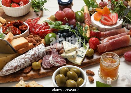 Set of different delicious appetizers served on white wooden table Stock Photo