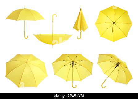 Set with stylish yellow umbrellas on white background Stock Photo