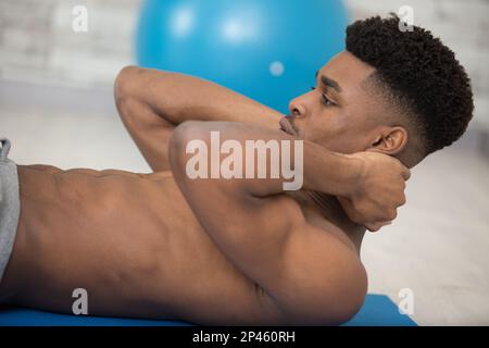 fitness man with perfect body doing abdominal exercises Stock Photo