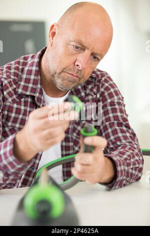 man assembling pipe in bathroom Stock Photo