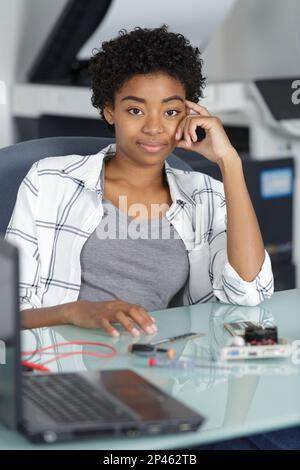 young female electronic engineer testing computer pc motherboard in laboratory Stock Photo